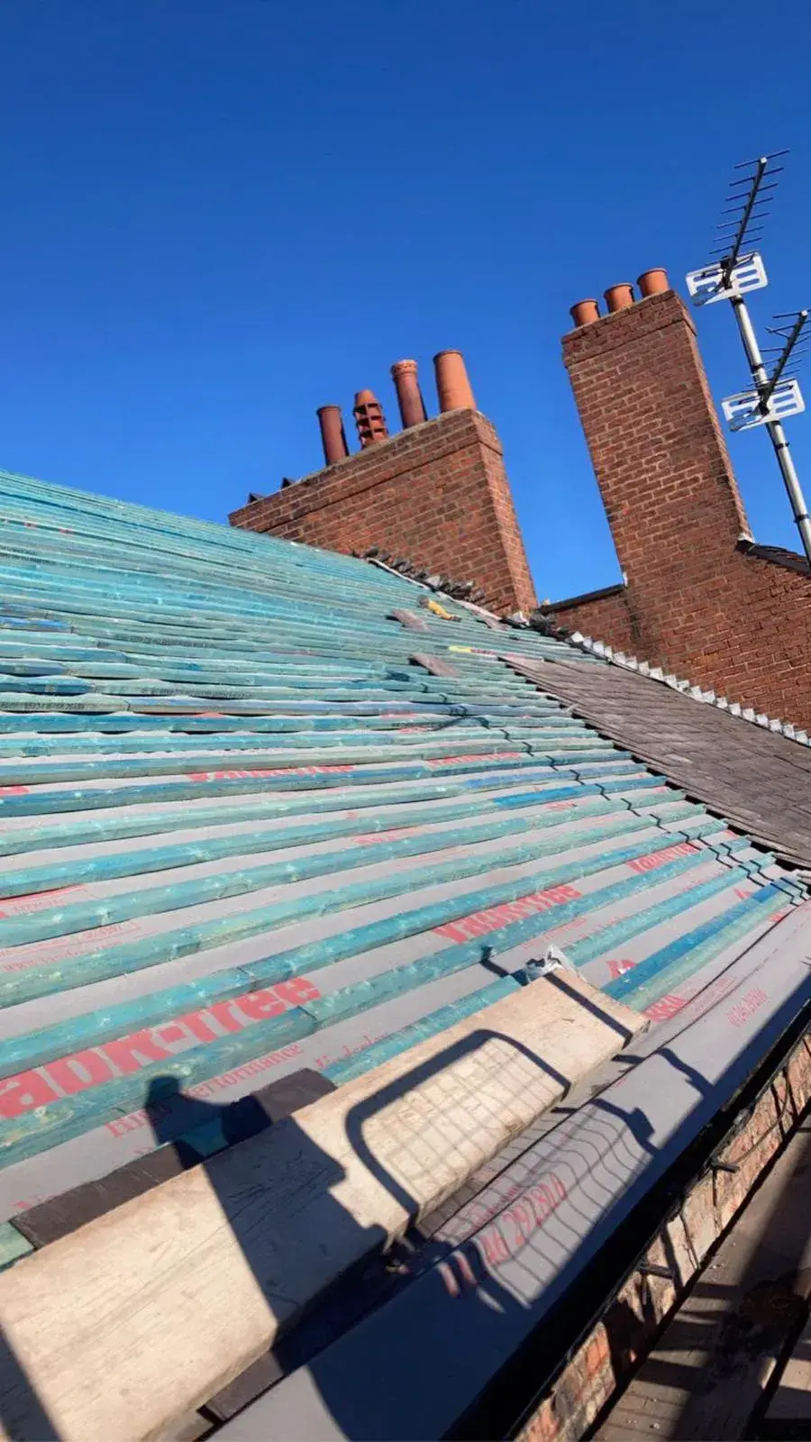 the roof of a building with a blue sky in the background