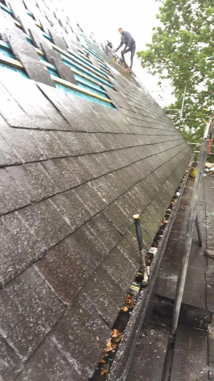 a man standing on top of a roof