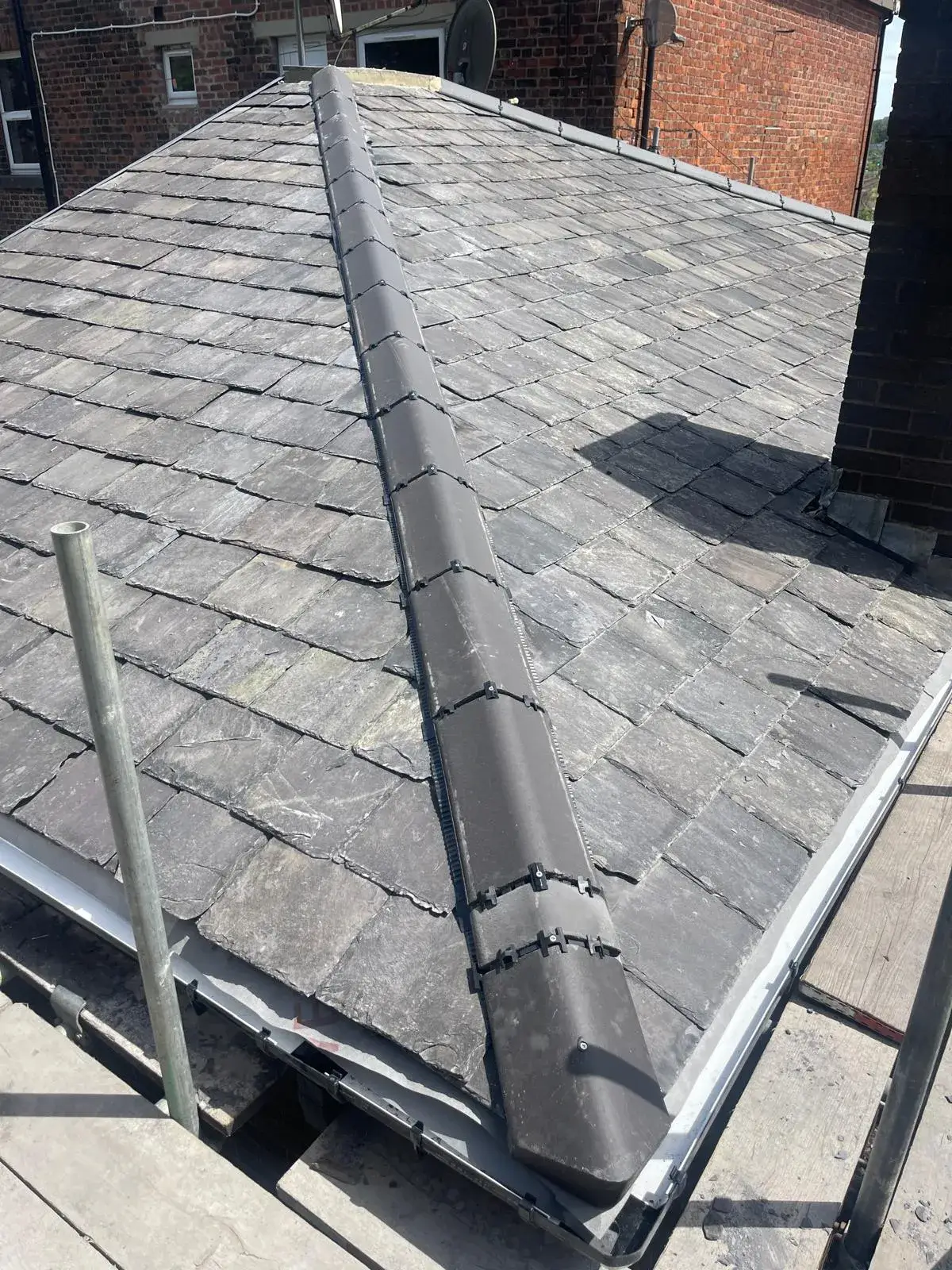 a flat roof with a metal gutter on top of it