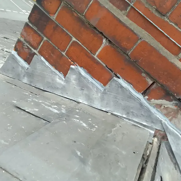 a close up of a piece of metal on a brick wall